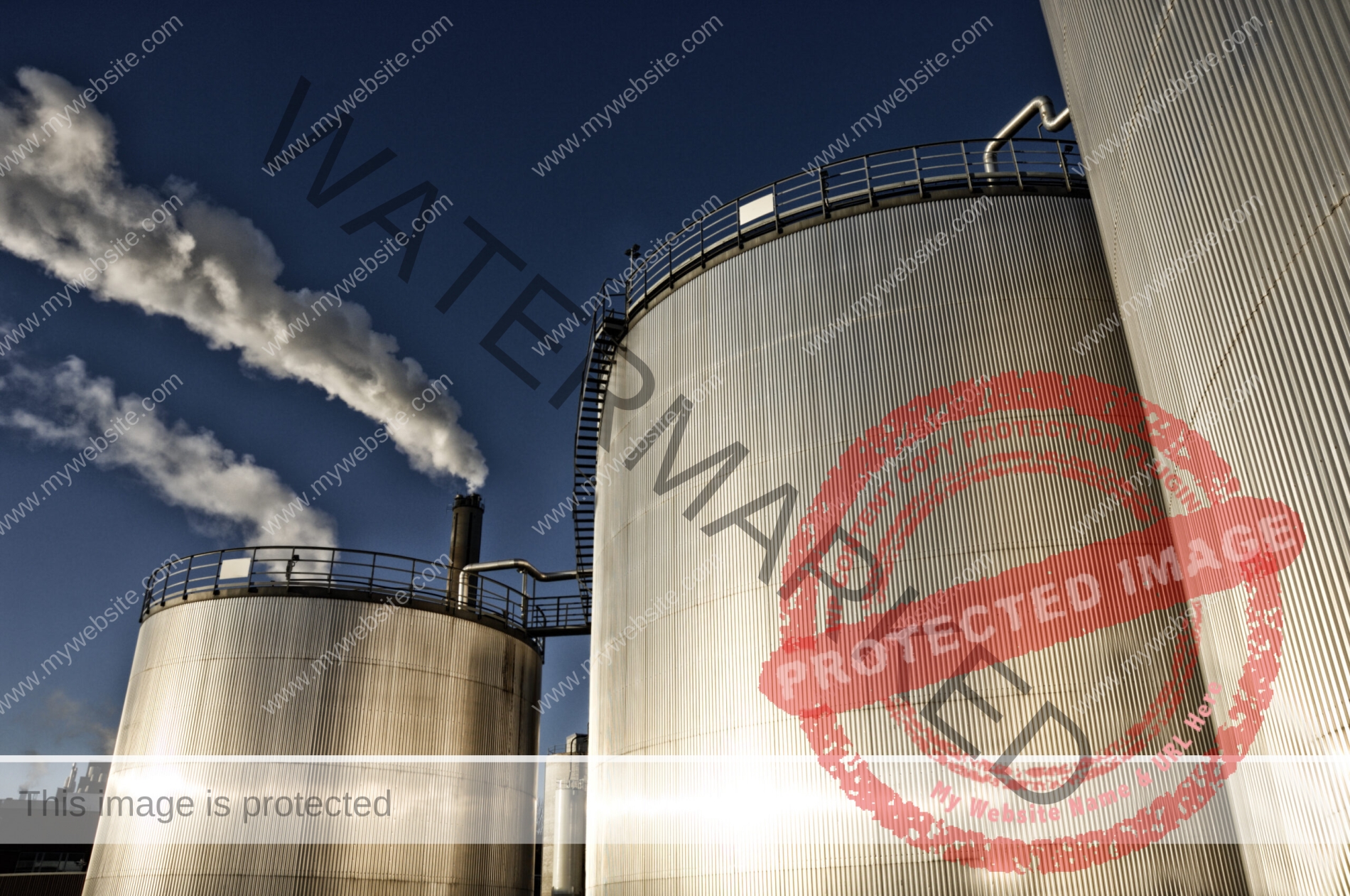 large fuel storage tanks at sunset